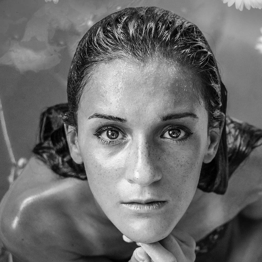 A woman with wet hair and no make up