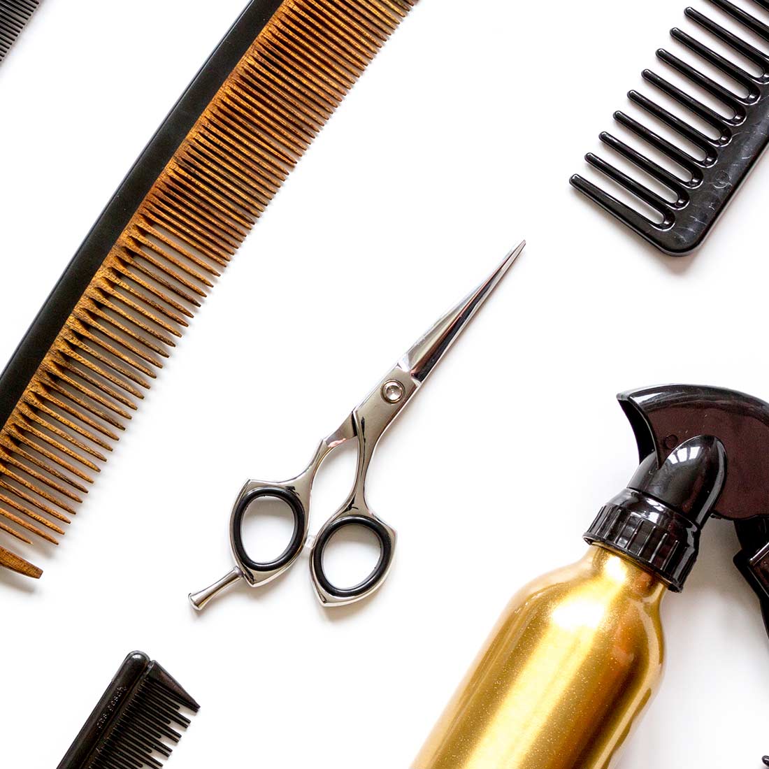 A table with hair products and combs on it.