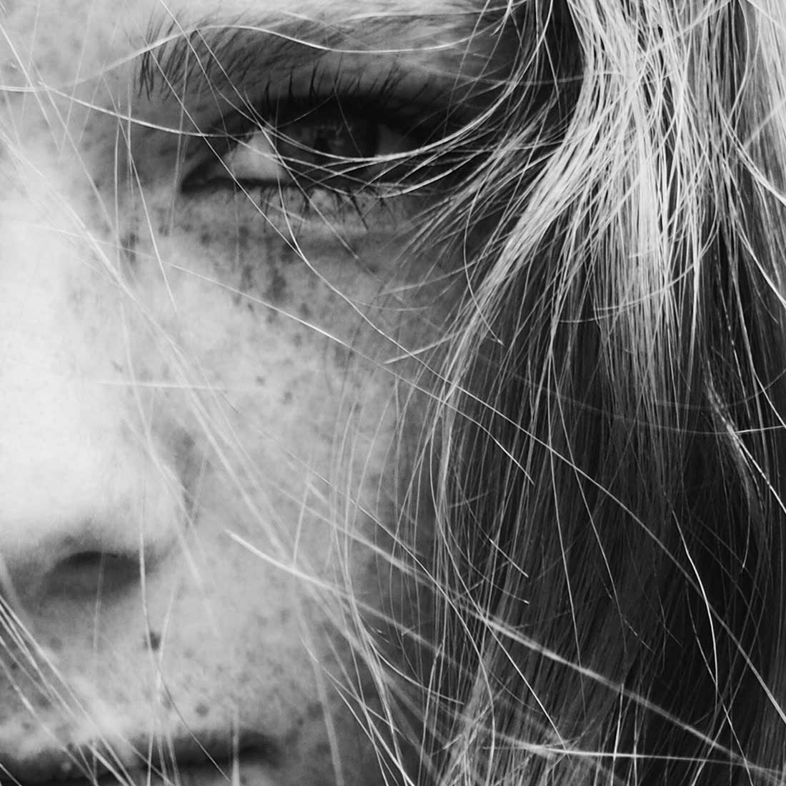 A woman with long hair and a nose ring.