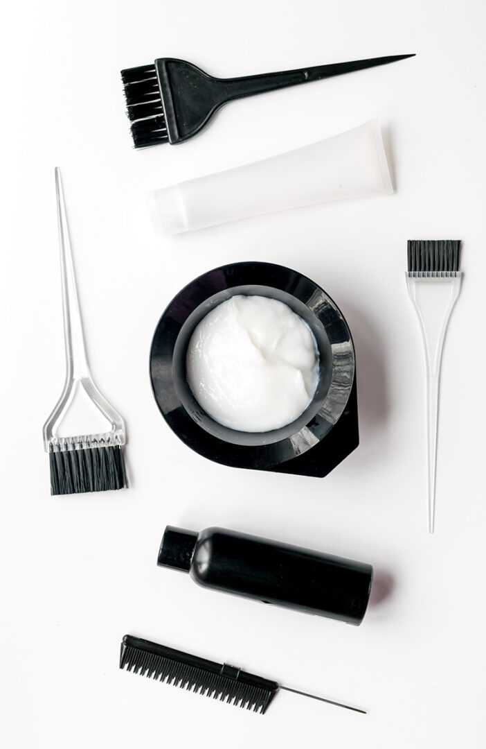 A white table with some hair products and brushes