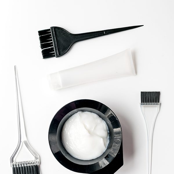 shop-image-12-gallery-1 A white table with some hair coloring products and brushes