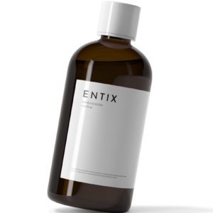 A bottle of liquid with white label on it.