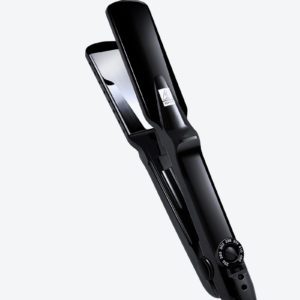 A black hair straightener sitting on top of a table.