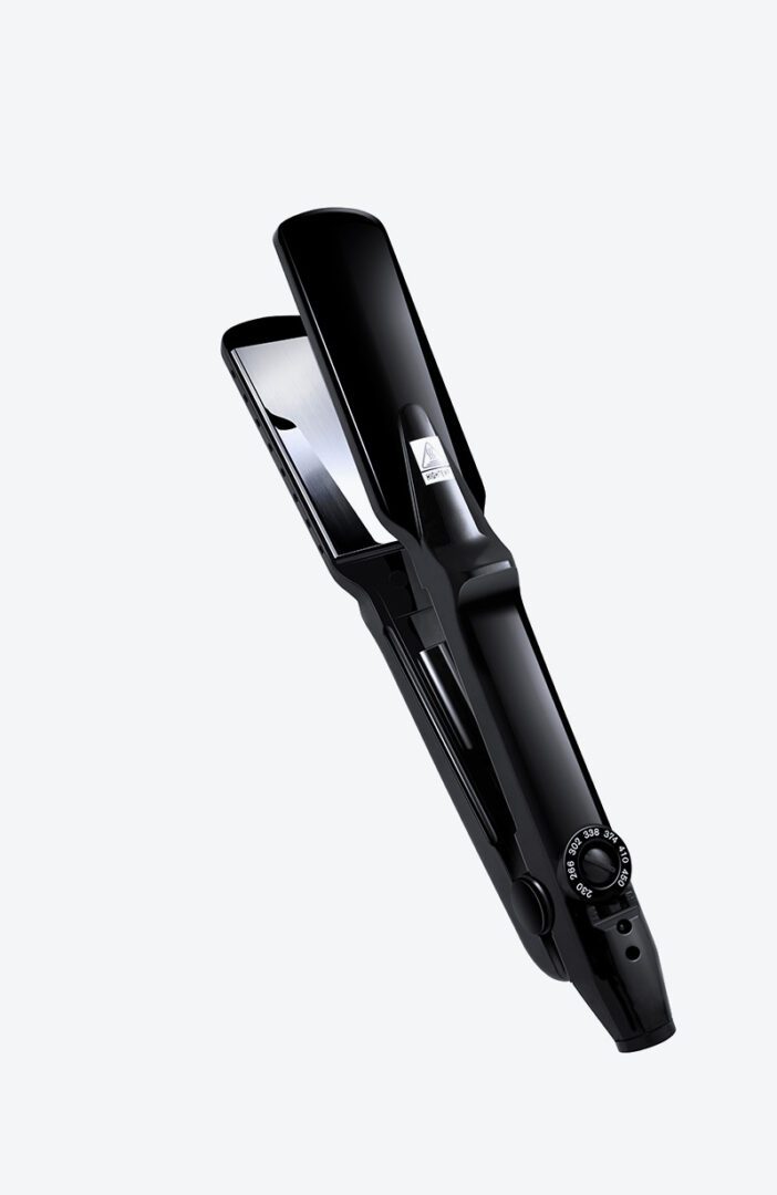 A black hair straightener sitting on top of a table.