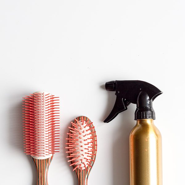 shop-image-7-gallery-1 A bottle of hair spray and two pink brushes.
