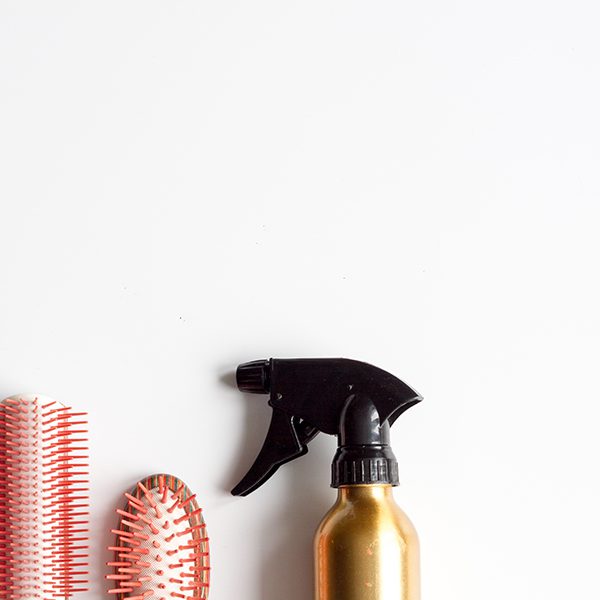 shop-image-7-gallery-2 A spray bottle and some hair brushes on the table.