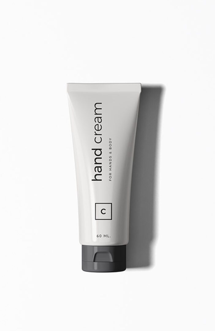 A white tube of hand cream sitting on top of a table.