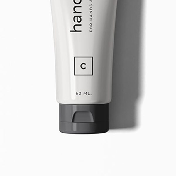 shop-image-9-gallery-3 A tube of hand cream sitting on top of a white surface.