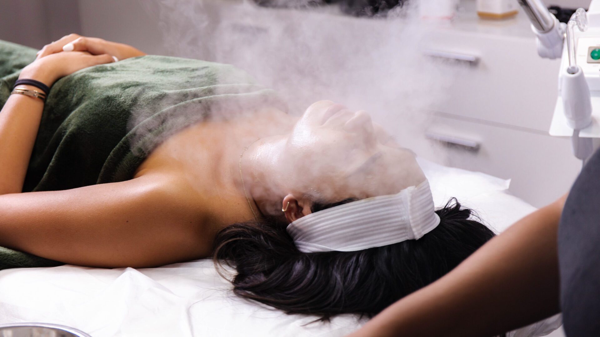 A woman laying on the bed with steam coming out of her head.