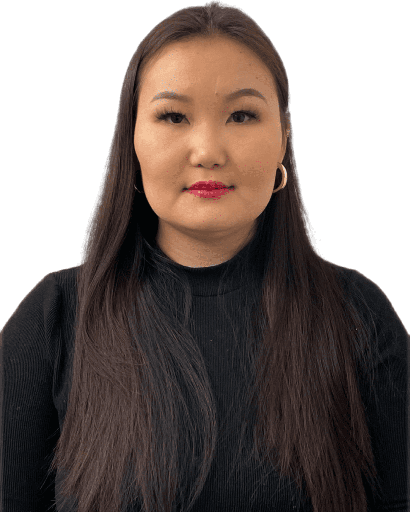 A woman with long hair wearing black and standing up.