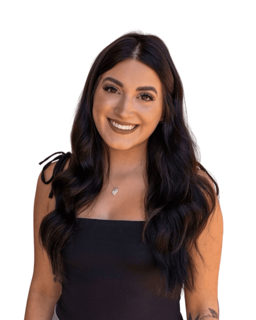 A woman with long black hair smiles for the camera.